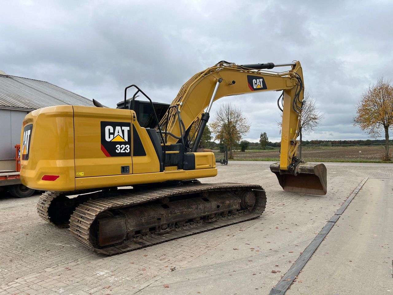 2018 Caterpillar 323 crawler excavator, rear three-quarter view 2018 Caterpillar 323 crawler excavator, rear three-quarter view