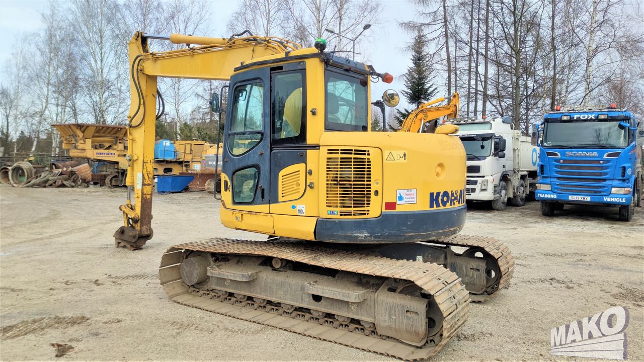 2013 Komatsu PC138US-8 crawler excavator, rear three-quarter view 2013 Komatsu PC138US-8 crawler excavator, rear three-quarter view