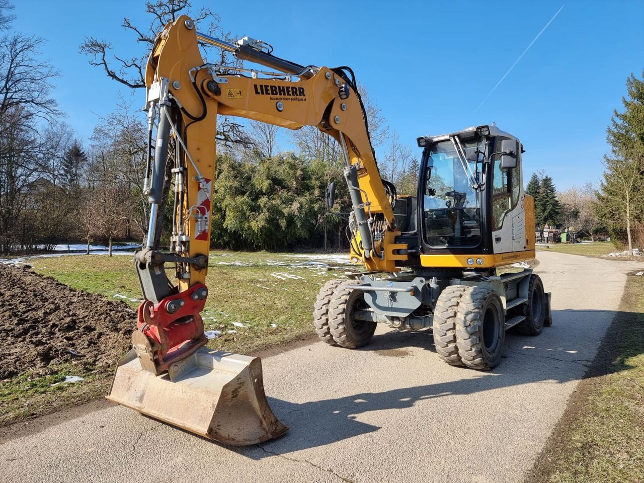 2024 Liebherr A910 Compact Litronic wheel excavator, front three-quarter view
