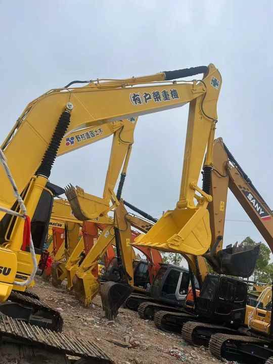 2022 Komatsu PC240-8 crawler excavator, side view of multiple machines 2022 Komatsu PC240-8 crawler excavator, side view of multiple machines