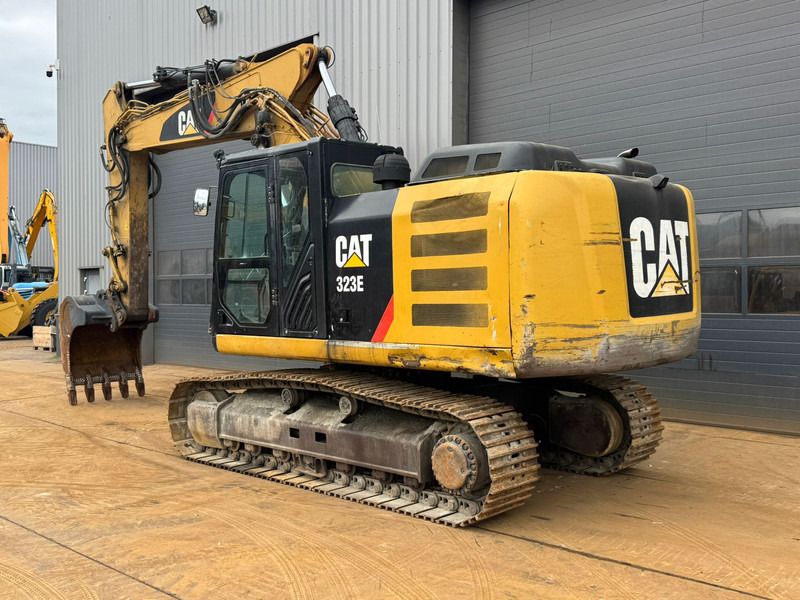 2012 Caterpillar 323E crawler excavator, rear three-quarter view 2012 Caterpillar 323E crawler excavator, rear three-quarter view