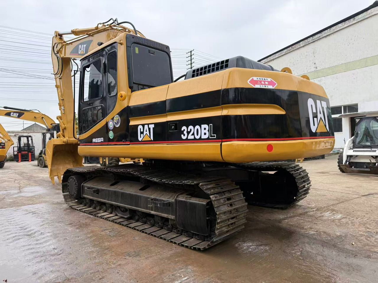 2010 Caterpillar 320BL crawler excavator, rear three-quarter view