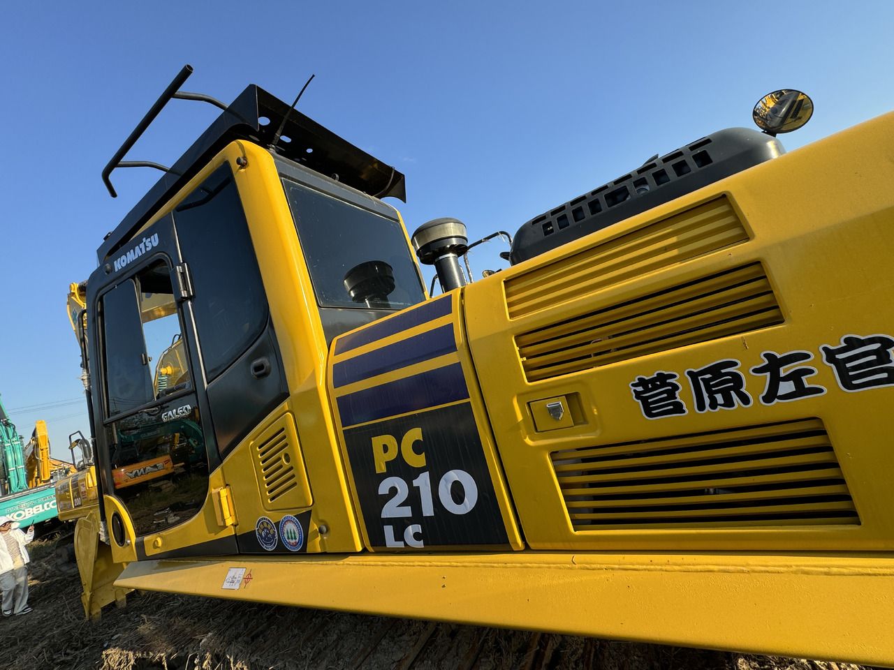 2022 Komatsu PC210LC excavator cab and engine housing side view