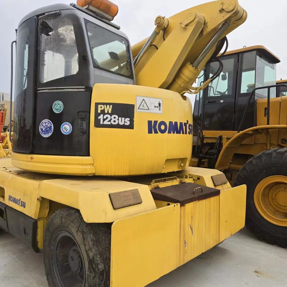2020 Komatsu PW128US wheel excavator, rear three-quarter view 2020 Komatsu PW128US wheel excavator, rear three-quarter view