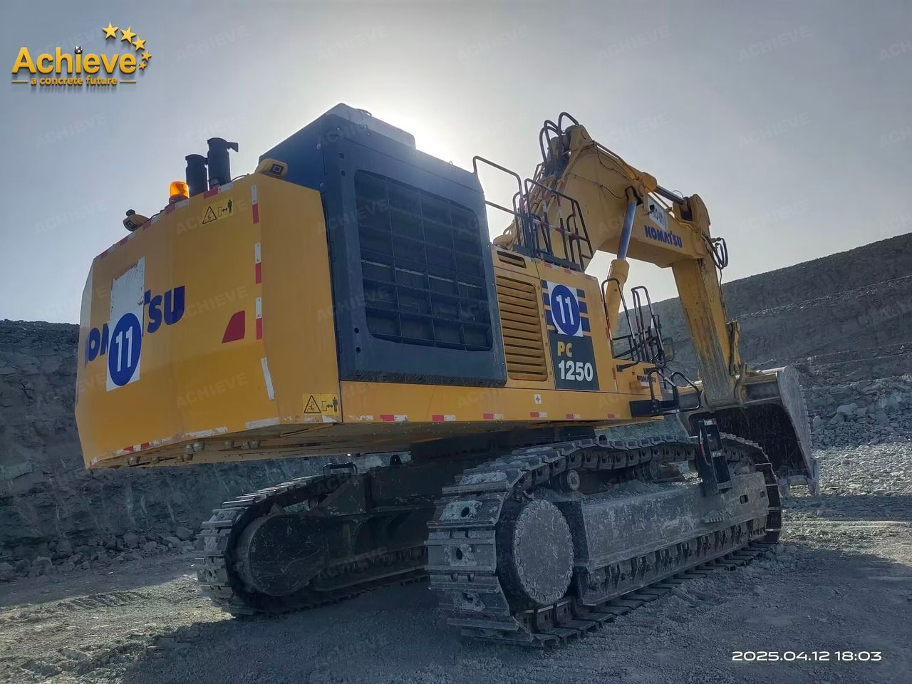 2022 Komatsu PC1250-11R crawler excavator, rear three-quarter view 2022 Komatsu PC1250-11R crawler excavator, rear three-quarter view