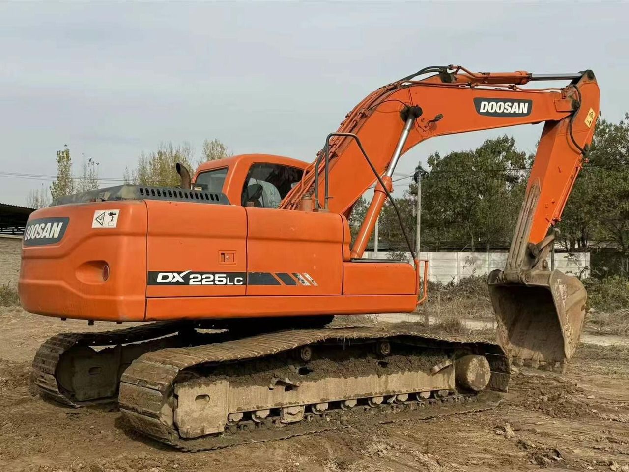 2022 Doosan DX225LC crawler excavator, rear three-quarter view 2022 Doosan DX225LC crawler excavator, rear three-quarter view