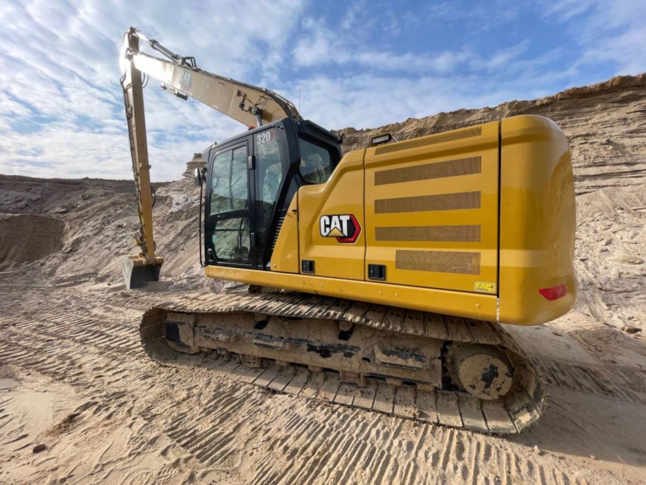 2022 Caterpillar 320 crawler excavator, rear three-quarter view 2022 Caterpillar 320 crawler excavator, rear three-quarter view