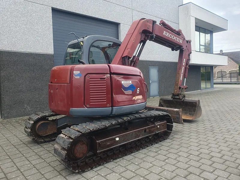 2005 New Holland E70 mini excavator, rear three-quarter view 2005 New Holland E70 mini excavator, rear three-quarter view