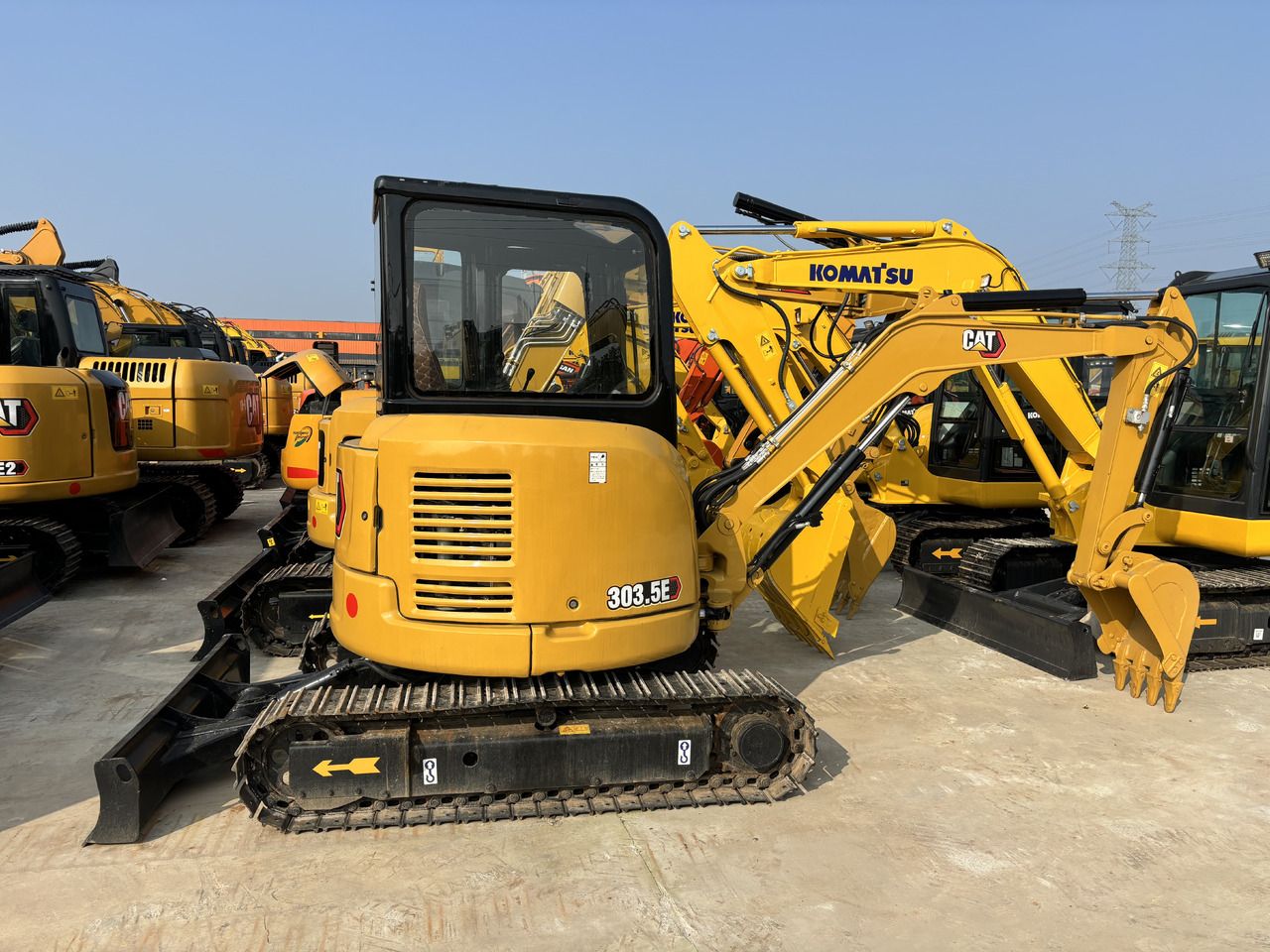 2023 Caterpillar 303.5E mini excavator, rear three-quarter view