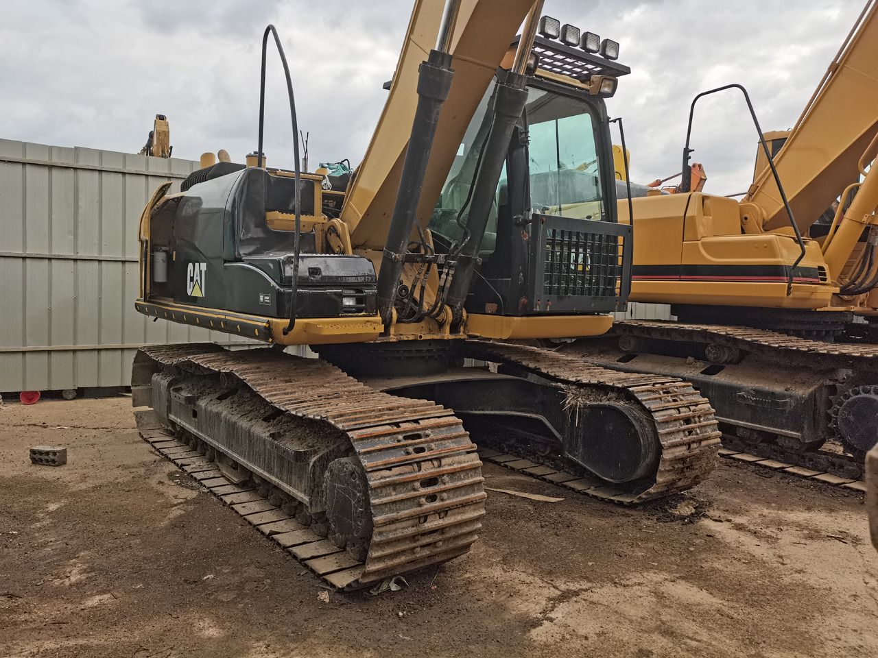 Caterpillar 312D2 crawler excavator, side view Caterpillar 312D2 crawler excavator, side view