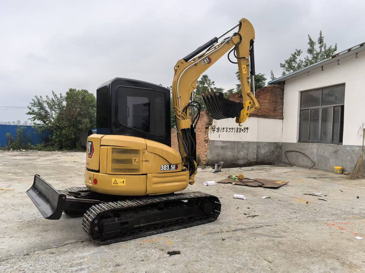 2023 Caterpillar 303.5E mini excavator, rear three-quarter view