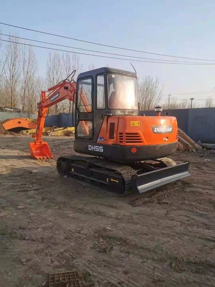 2023 Doosan DH55 mini excavator, rear three-quarter view