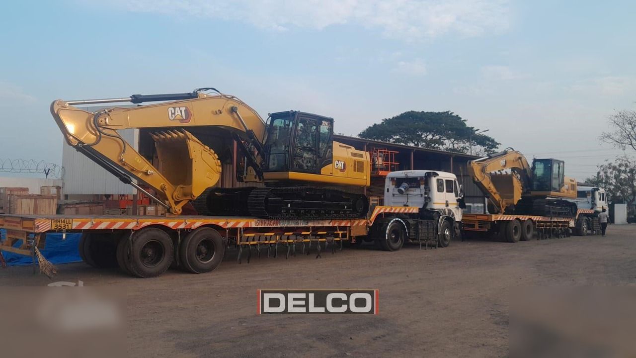 2026 Caterpillar 324 crawler excavator on a flatbed trailer, side view