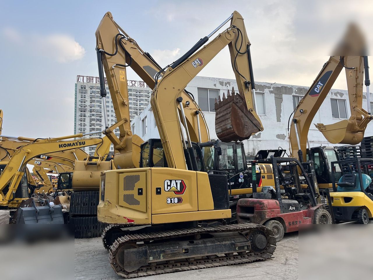 2019 Caterpillar 310 crawler excavator, rear three-quarter view