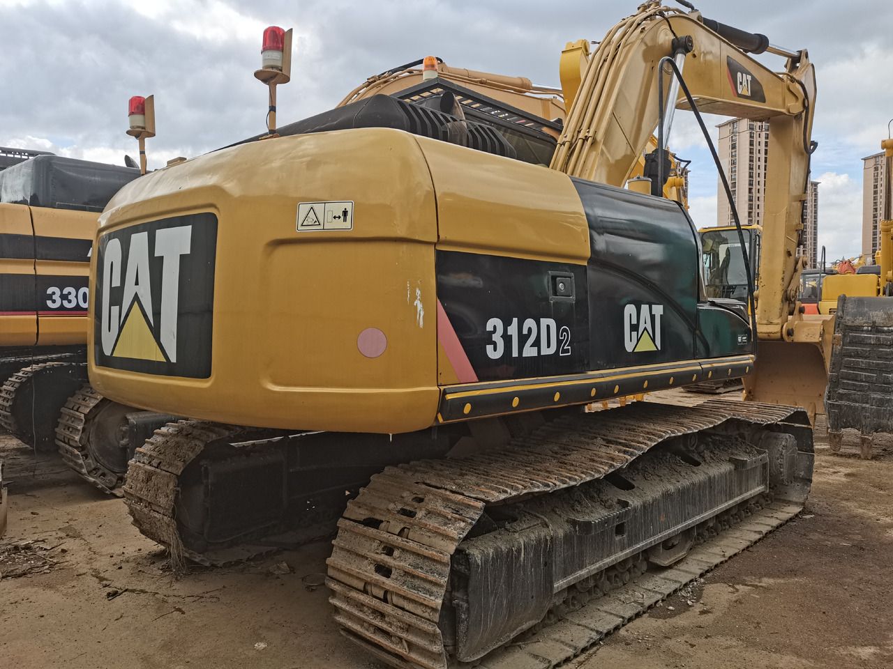 Caterpillar 312D2 crawler excavator, rear three-quarter view Caterpillar 312D2 crawler excavator, rear three-quarter view