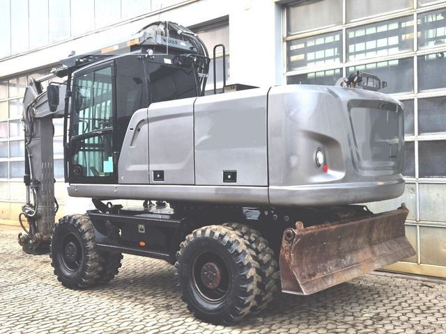 2020 Caterpillar M320F wheel excavator, rear three-quarter view 2020 Caterpillar M320F wheel excavator, rear three-quarter view
