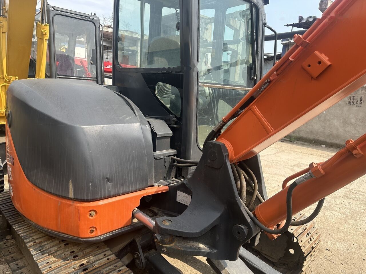 Hitachi ZX65 mini excavator, side view of cab and boom Hitachi ZX65 mini excavator, side view of cab and boom