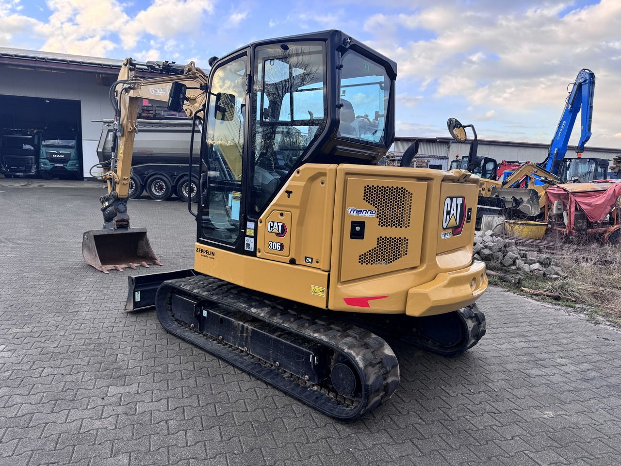 2022 Caterpillar 306CR mini excavator, rear three-quarter view 2022 Caterpillar 306CR mini excavator, rear three-quarter view