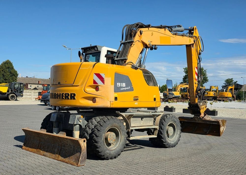 2014 Liebherr A918 Compact wheel excavator, rear three-quarter view 2014 Liebherr A918 Compact wheel excavator, rear three-quarter view