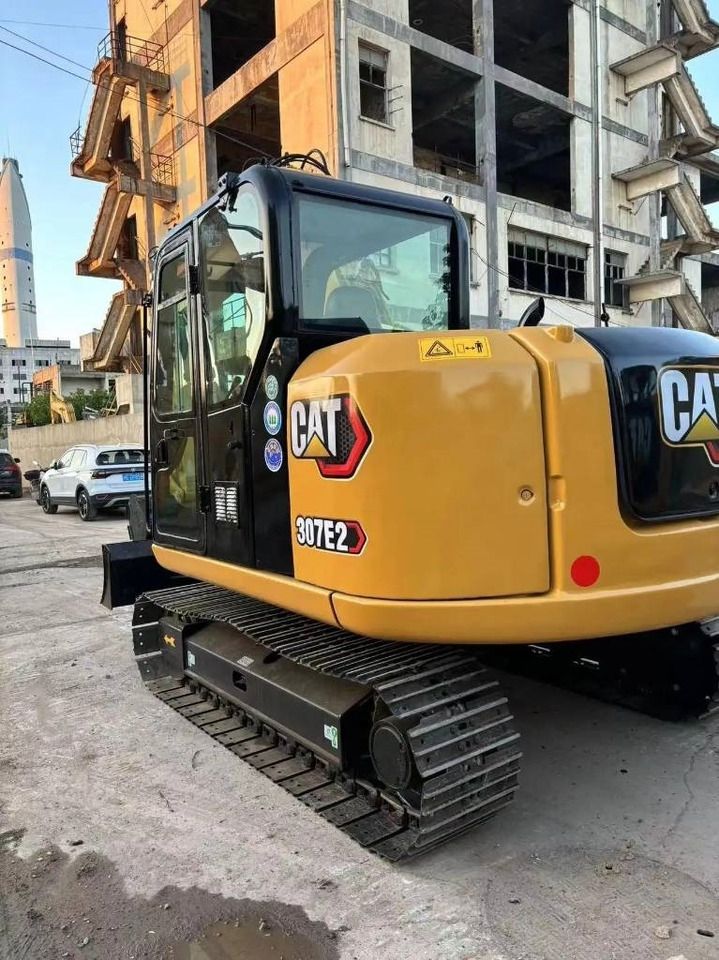 2023 Caterpillar 307E2 mini excavator, rear three-quarter view 2023 Caterpillar 307E2 mini excavator, rear three-quarter view