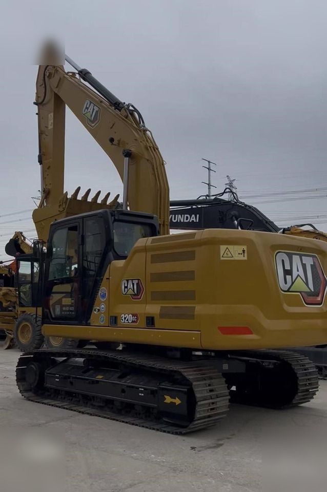 2023 Caterpillar 320GC crawler excavator, rear three-quarter view
