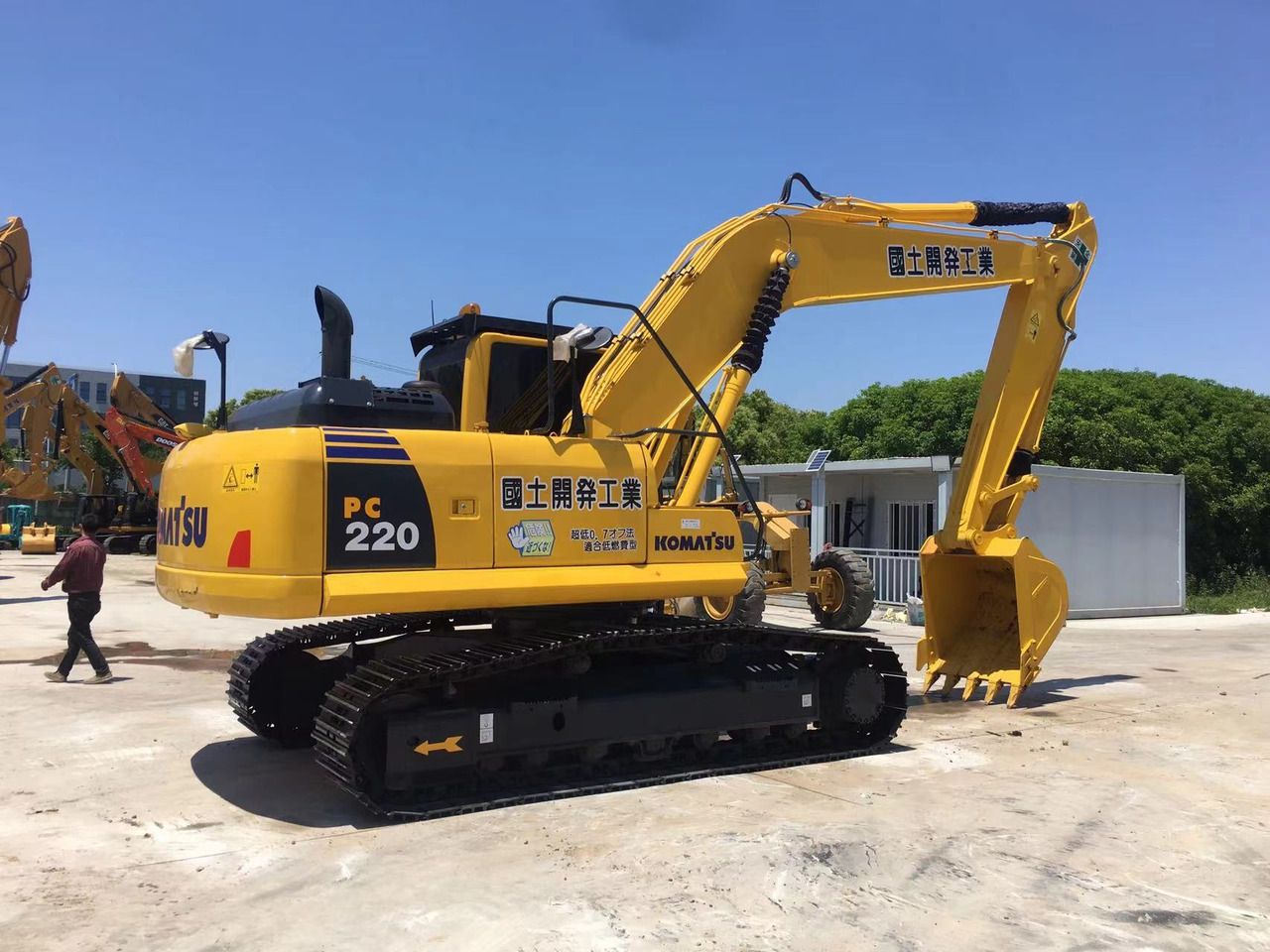 Escavatore cingolato Komatsu PC220-8 del 2023, vista posteriore tre quarti Escavatore cingolato Komatsu PC220-8 del 2023, vista posteriore tre quarti