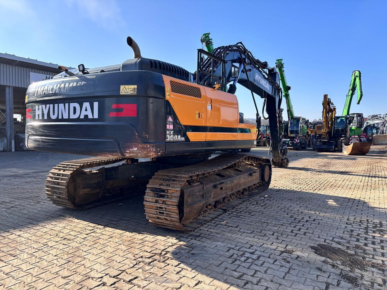 2022 Hyundai HX300ANL crawler excavator, rear three-quarter view 2022 Hyundai HX300ANL crawler excavator, rear three-quarter view