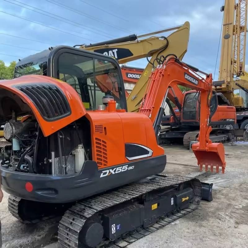 2023 Doosan DX55-9C mini excavator, rear three-quarter view with engine cover open 2023 Doosan DX55-9C mini excavator, rear three-quarter view with engine cover open