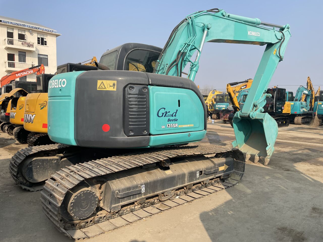 2023 Kobelco SK135SR Grand Beetle crawler excavator, rear three-quarter view