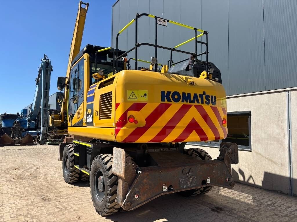 2022 Komatsu PW180 wheel excavator, rear three-quarter view 2022 Komatsu PW180 wheel excavator, rear three-quarter view