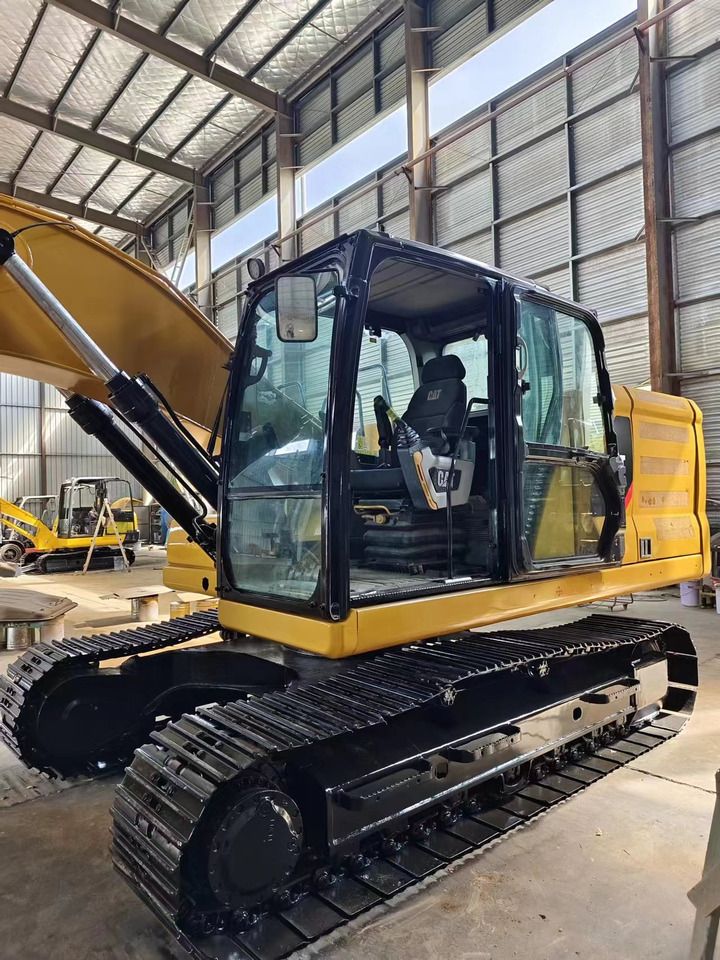 2023 Caterpillar 320GC crawler excavator, side view of cab and tracks 2023 Caterpillar 320GC crawler excavator, side view of cab and tracks