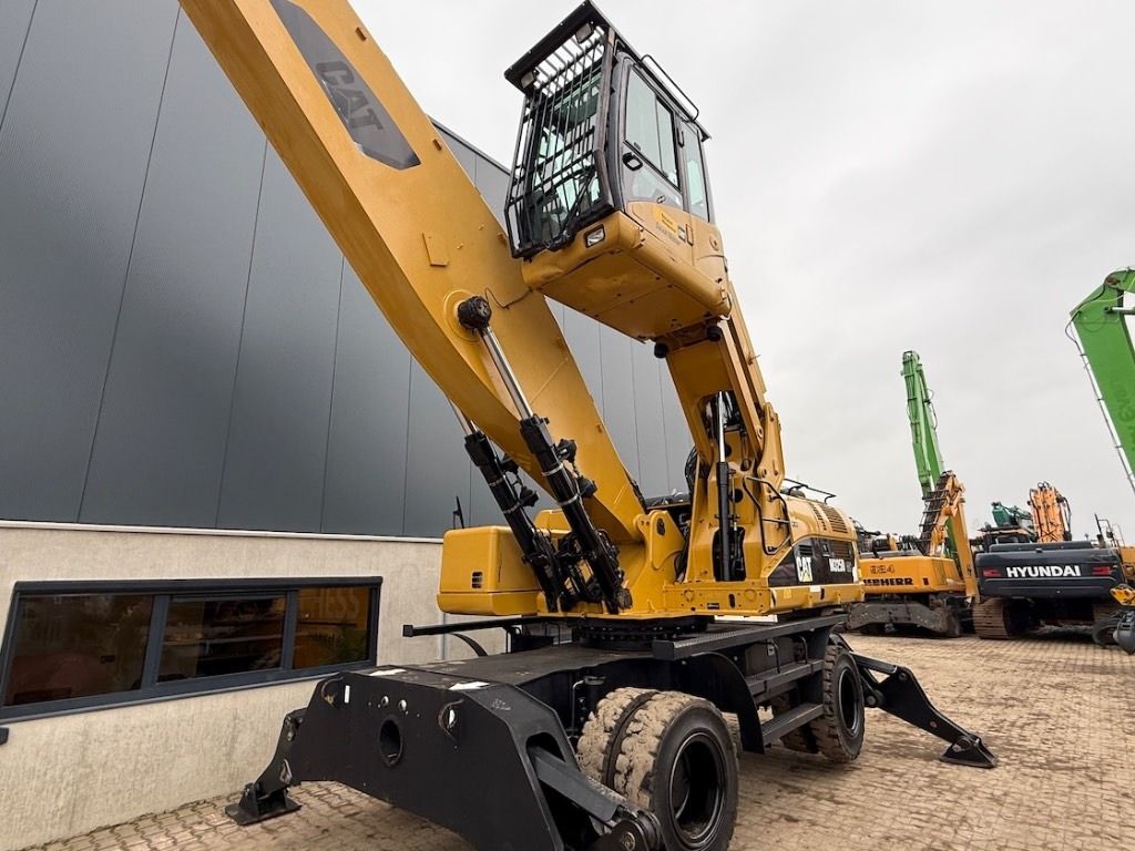 2008 Caterpillar 325D material handler, low-angle side view