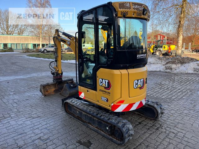 2022 Caterpillar 302 mini excavator, rear three-quarter view