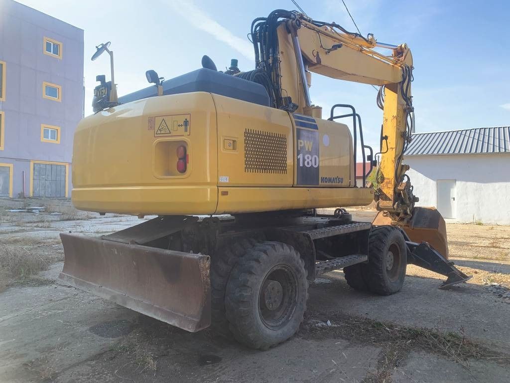 2012 Komatsu PW180-E0 wheel excavator, rear three-quarter view 2012 Komatsu PW180-E0 wheel excavator, rear three-quarter view