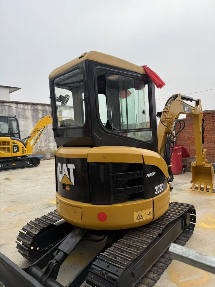 2023 Caterpillar 303CR mini excavator, rear three-quarter view 2023 Caterpillar 303CR mini excavator, rear three-quarter view