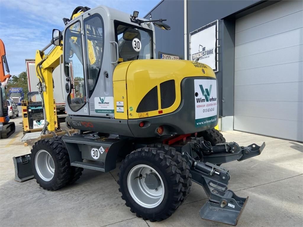 2022 Wacker Neuson EW100 wheel excavator, rear three-quarter view