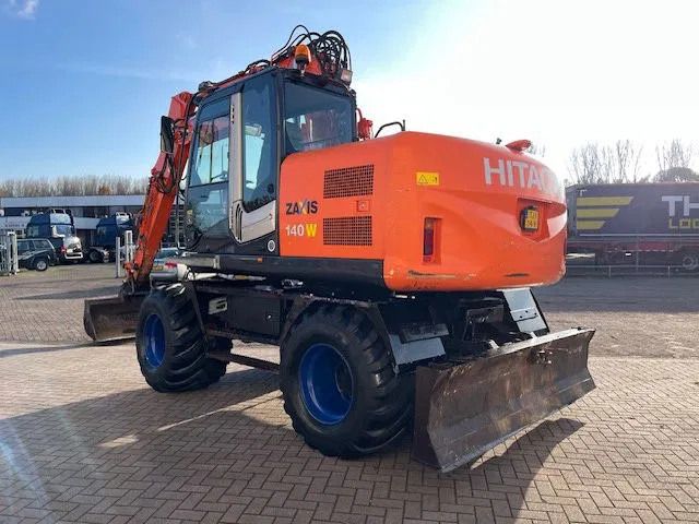 2011 Hitachi Zaxis 140W wheel excavator, rear three-quarter view 2011 Hitachi Zaxis 140W wheel excavator, rear three-quarter view