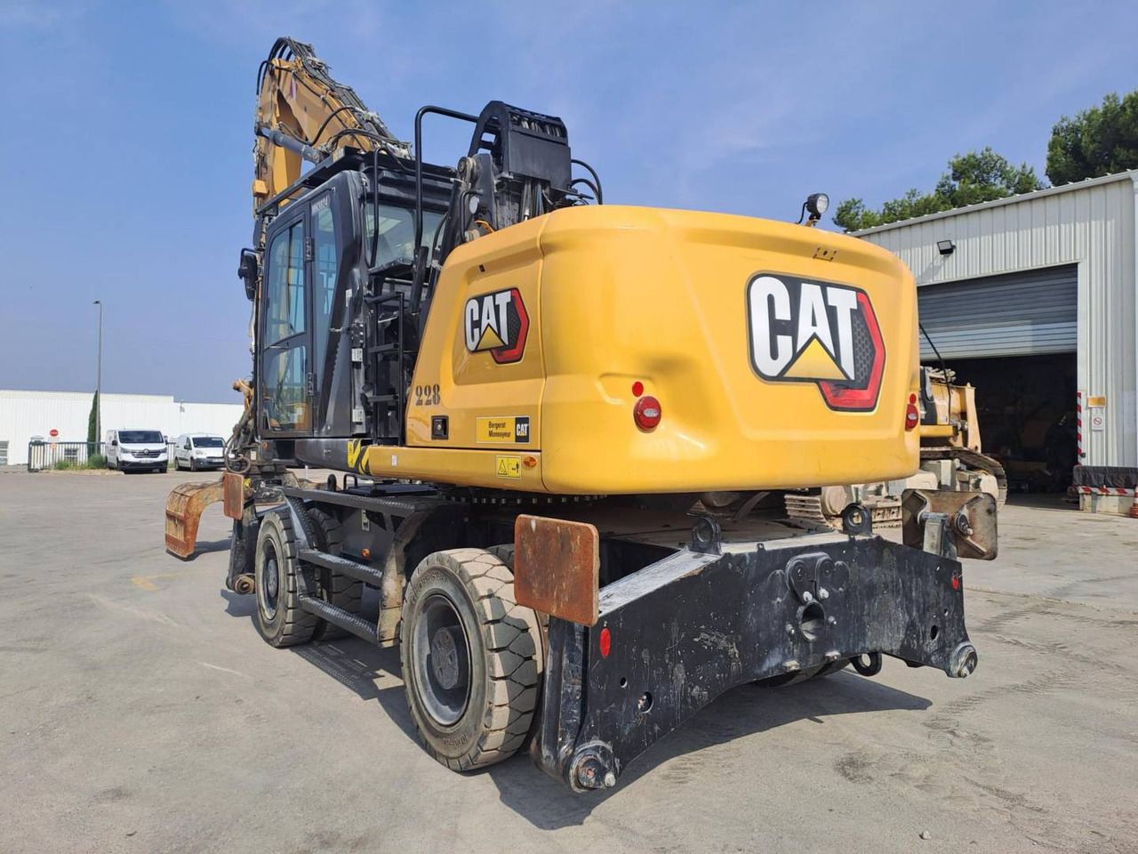 2024 Caterpillar MH3024 wheel excavator, rear three-quarter view