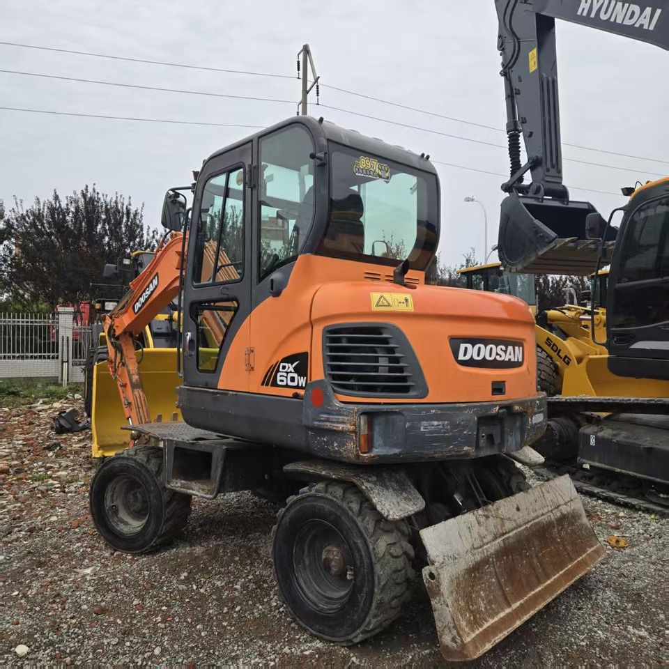 2018 Doosan DX60W wheel excavator, rear three-quarter view 2018 Doosan DX60W wheel excavator, rear three-quarter view