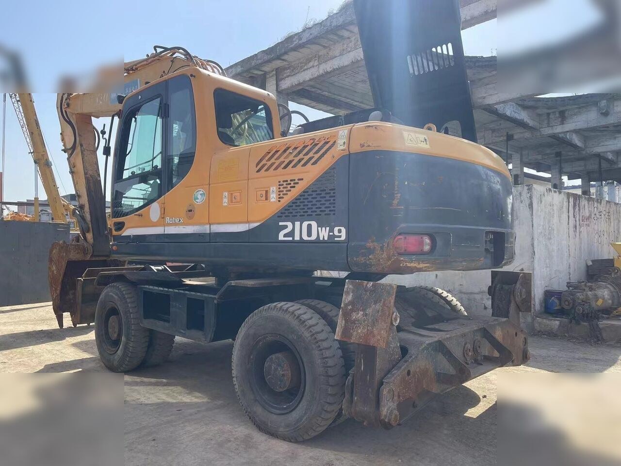 2024 Hyundai R210W-9 wheel excavator, rear three-quarter view 2024 Hyundai R210W-9 wheel excavator, rear three-quarter view