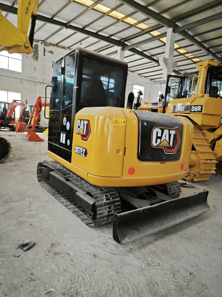 Caterpillar 307E2 mini excavator, rear three-quarter view