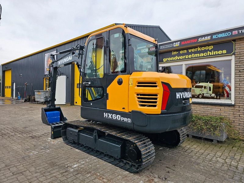 2025 Hyundai HX60PRO mini excavator, rear three-quarter view 2025 Hyundai HX60PRO mini excavator, rear three-quarter view