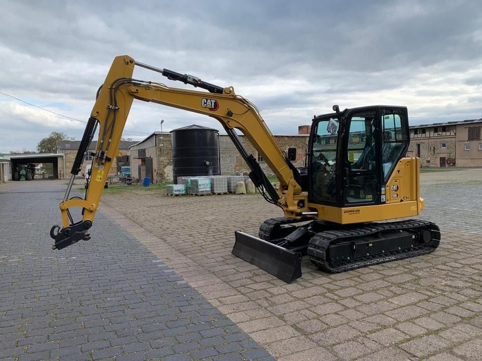 Caterpillar 306CR-07A mini excavator, side view Caterpillar 306CR-07A mini excavator, side view