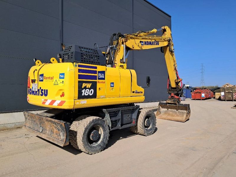2023 Komatsu PW180-11E0 wheel excavator, rear three-quarter view 2023 Komatsu PW180-11E0 wheel excavator, rear three-quarter view