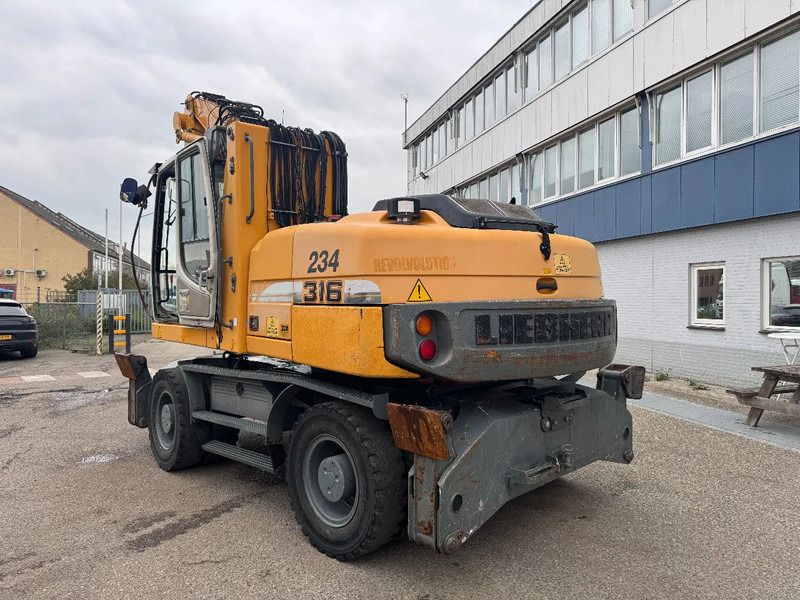 2009 Liebherr A316 LITRONIC material handler, rear three-quarter view 2009 Liebherr A316 LITRONIC material handler, rear three-quarter view