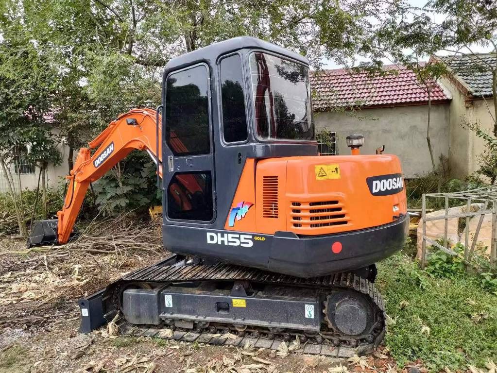 2022 Doosan DH55 Gold mini excavator, rear three-quarter view