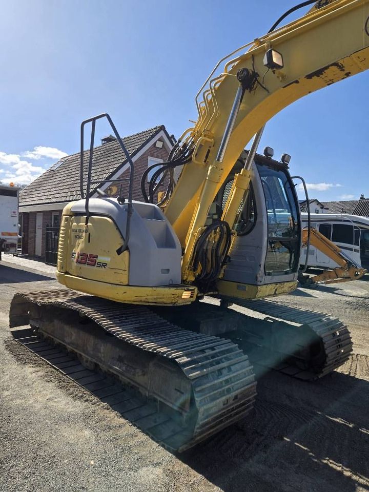 2006 New Holland E135SR-1E crawler excavator, rear three-quarter view 2006 New Holland E135SR-1E crawler excavator, rear three-quarter view
