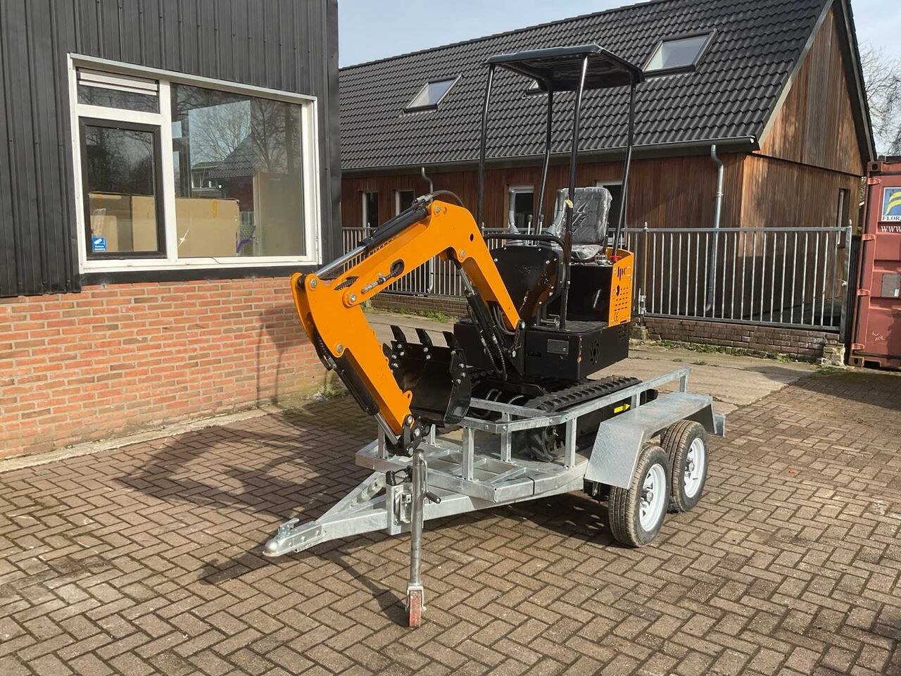 JPC HT-12 mini excavator on trailer, side view JPC HT-12 mini excavator on trailer, side view