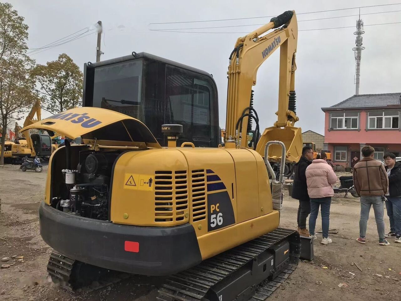 2021 Komatsu PC56 mini excavator, rear three-quarter view with engine cover open 2021 Komatsu PC56 mini excavator, rear three-quarter view with engine cover open