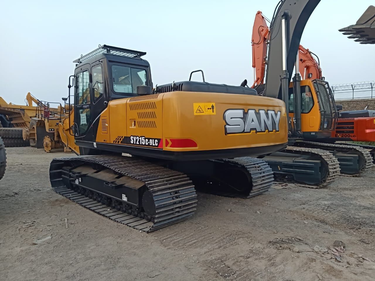 2025 Mitsubishi SY 215 crawler excavator, rear three-quarter view 2025 Mitsubishi SY 215 crawler excavator, rear three-quarter view